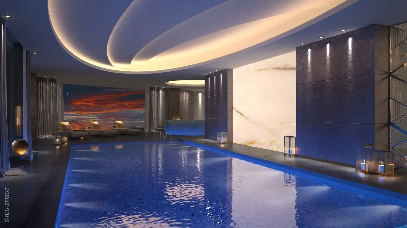 Indoor swimming pool with curved ceiling and luxury finishes in the Ascott Al-Khobar Hotel designed by Blu Beirut.