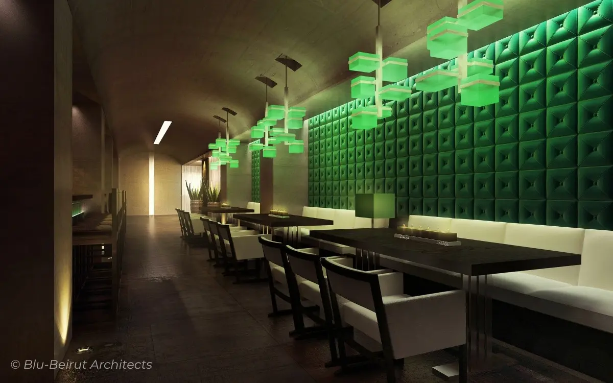 Modern English pub dining space with green-tiled accent wall and white seating, blending urban minimalism with contextual vibrancy by Blu-Beirut
