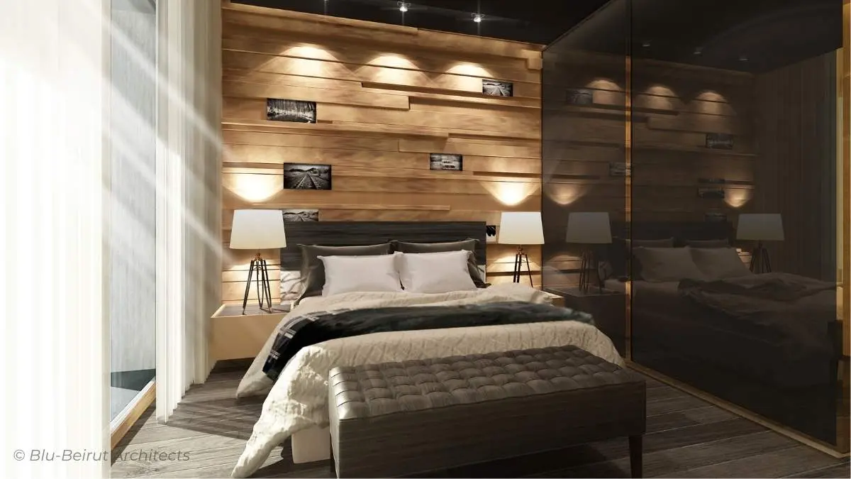 Minimalist mountain chalet bedroom with wooden ceiling, integrated lighting, and matte black accents – cozy yet refined design by Blu-Beirut