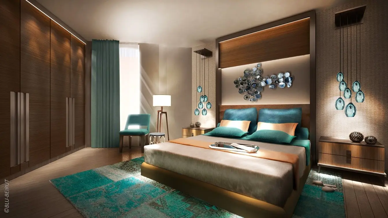 Luxury hotel bedroom design featuring emerald palette, modern furnishings, and wood paneling in a furnished suite at Ascott Corniche Al Khobar.